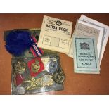 Various military cap badges including 'Manchester', 'RAF' etc, WWII ration and ID books of G.Gamin
