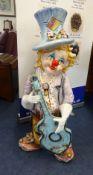 A large ceramic child clown playing guitar, height 3ft.