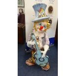 A large ceramic child clown playing guitar, height 3ft.