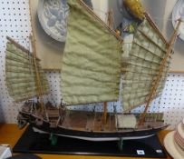 A model of a Chinese junk on a wood base, width 70cm.