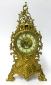 A French ornate brass clock with bell striking movement, with key, height 40cm.