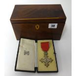 An MBE medal, cased, together with a 19th Century mahogany tea caddy.
