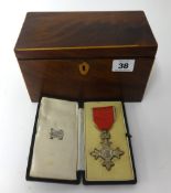 An MBE medal, cased, together with a 19th Century mahogany tea caddy.