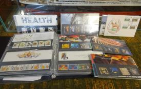 An album of First Day Covers also loose commemorative issue stamp sets.