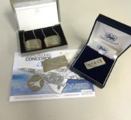 Concorde, a sterling silver clip, a silver commemorative ingot, a pair of Concorde silver decanter