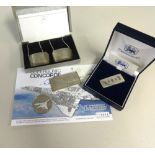 Concorde, a sterling silver clip, a silver commemorative ingot, a pair of Concorde silver decanter