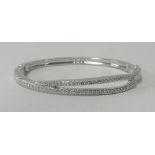 Swarovski, a white metal and crystal set bangle.