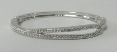 Swarovski, a white metal and crystal set bangle.
