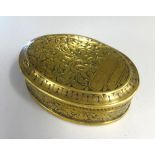 A Georgian oval brass tobacco box decorated with tobacco plant, approx 14cm x 10cm.