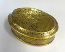 A Georgian oval brass tobacco box decorated with tobacco plant, approx 14cm x 10cm.