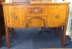 A Georgian inlaid and bow fronted mahogany sideboard fitted with two deep drawers (one a