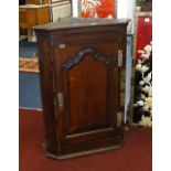 A 19th century mahogany hanging corner cupboard