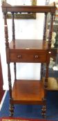 Victorian mahogany three tier what not, fitted with a drawer on brass castors, height 143cm.