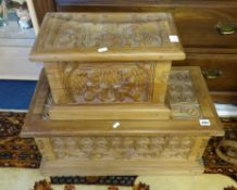 A carved wood two part seat and two carved wood small chests.