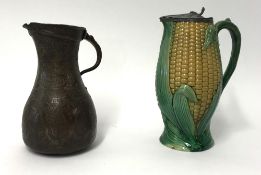 A Victorian majolica style 'corn cob' jug with a metal lid, together with a Middle Eastern jug,