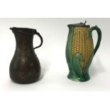 A Victorian majolica style 'corn cob' jug with a metal lid, together with a Middle Eastern jug,