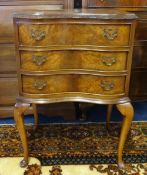 A reproduction walnut serpentine fronted three drawer chest, width 52cm.