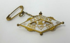 An enamel and gilt brooch, 'Sand Down Park 1915', width 40mm.