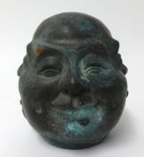 A 20th century Oriental bronze effect four face figure with character mark, height 14cm.