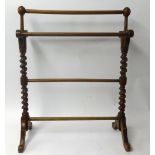 A towel rail with barley twist supports.