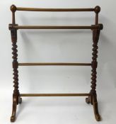 A towel rail with barley twist supports.