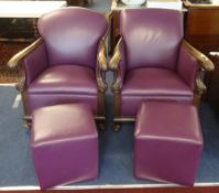 Two wood framed armchairs with later purple leather upholstery and similar pouffes.