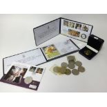 A collection of various commemorative coins including Jubilee Mint first day covers, London Mint