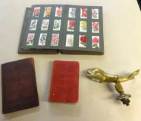 Various items including heavy dolphin brass door knocker, part album of cigarette cards, Masonic