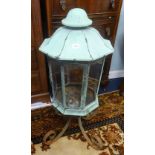 An antique copper lantern originally fitted for gas on a wrought iron stand, height 85cm.