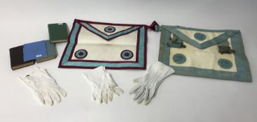 A collection of masonic regalia including apron, gloves, books, etc.