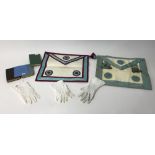 A collection of masonic regalia including apron, gloves, books, etc.