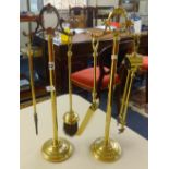 Two brass fire companion sets.