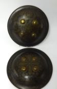 A pair of 19th/early 20th Century Indo-Persian shields, each fitted with arm supports and