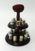 A collection of Royal Crown Derby thimbles on stand (15).