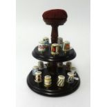 A collection of Royal Crown Derby thimbles on stand (15).