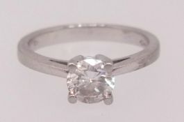A diamond solitaire ring set in platinum, the round brilliant