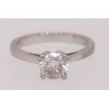 A diamond solitaire ring set in platinum, the round brilliant