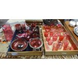 A collection of cranberry and ruby glass including Victorian, Mary Gregory style, jugs, decanters