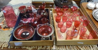 A collection of cranberry and ruby glass including Victorian, Mary Gregory style, jugs, decanters