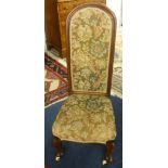 Victorian mahogany framed nursing chair with cabriole legs and white china castors.