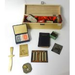 A modern pocket sundial and compass together with a box of various booklets, vintage items, studs