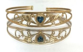 A 9ct gold bangle set with heart shaped blue stone, approx 6.60gms.