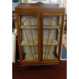 A stained wood display cabinet with art deco design.