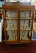 A stained wood display cabinet with art deco design.