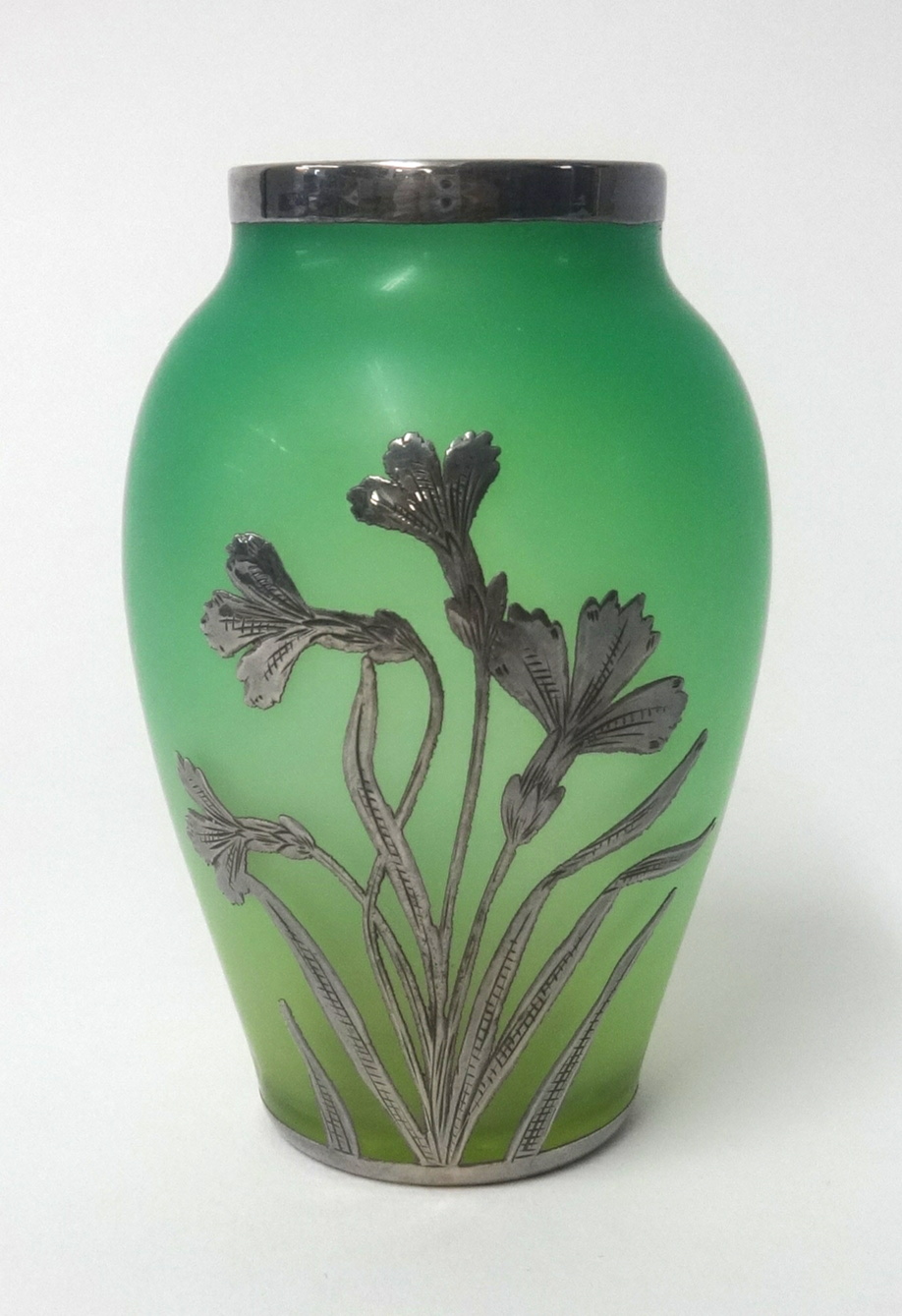 A small green glass vase with silver overlay decoration, height 11cm.