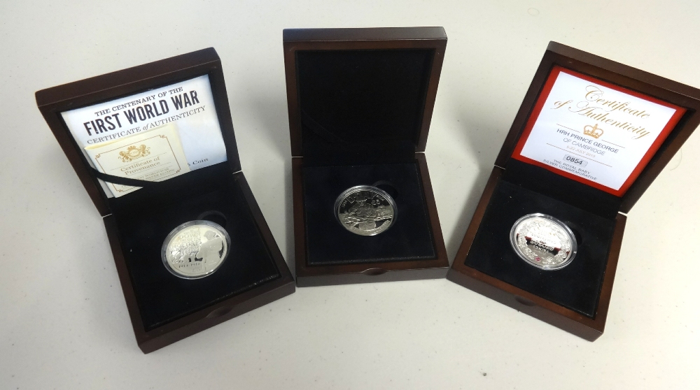 Three commemorative silver proof coins including Jersey D-Day, WWI and Prince George, boxed with