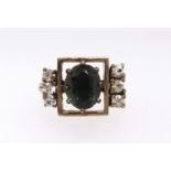 An 18ct spinel style and diamond ring, oval cut green synthetic spinel and six brilliant cut