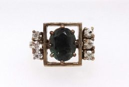 An 18ct spinel style and diamond ring, oval cut green synthetic spinel and six brilliant cut