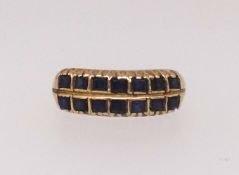 A two row sapphire dress ring, each row comprising seven square cut sapphires mounted in all