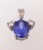 A tanzanite and diamond three stone pendant, the main stone approx 4.85ct, the round cut diamonds